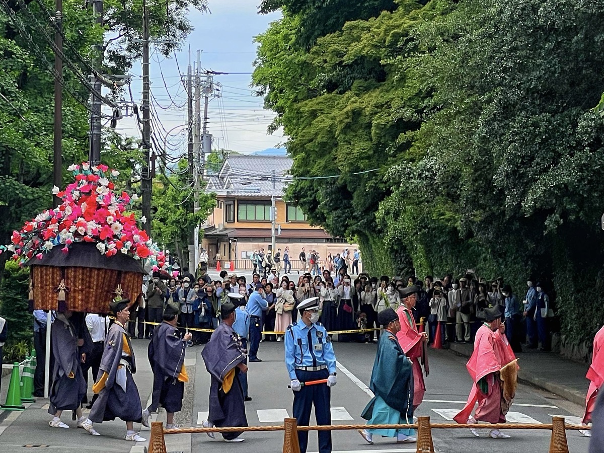 Aoi Matsuri procession in Kyoto with a flower-decorated cart and participants in Heian-era court costume