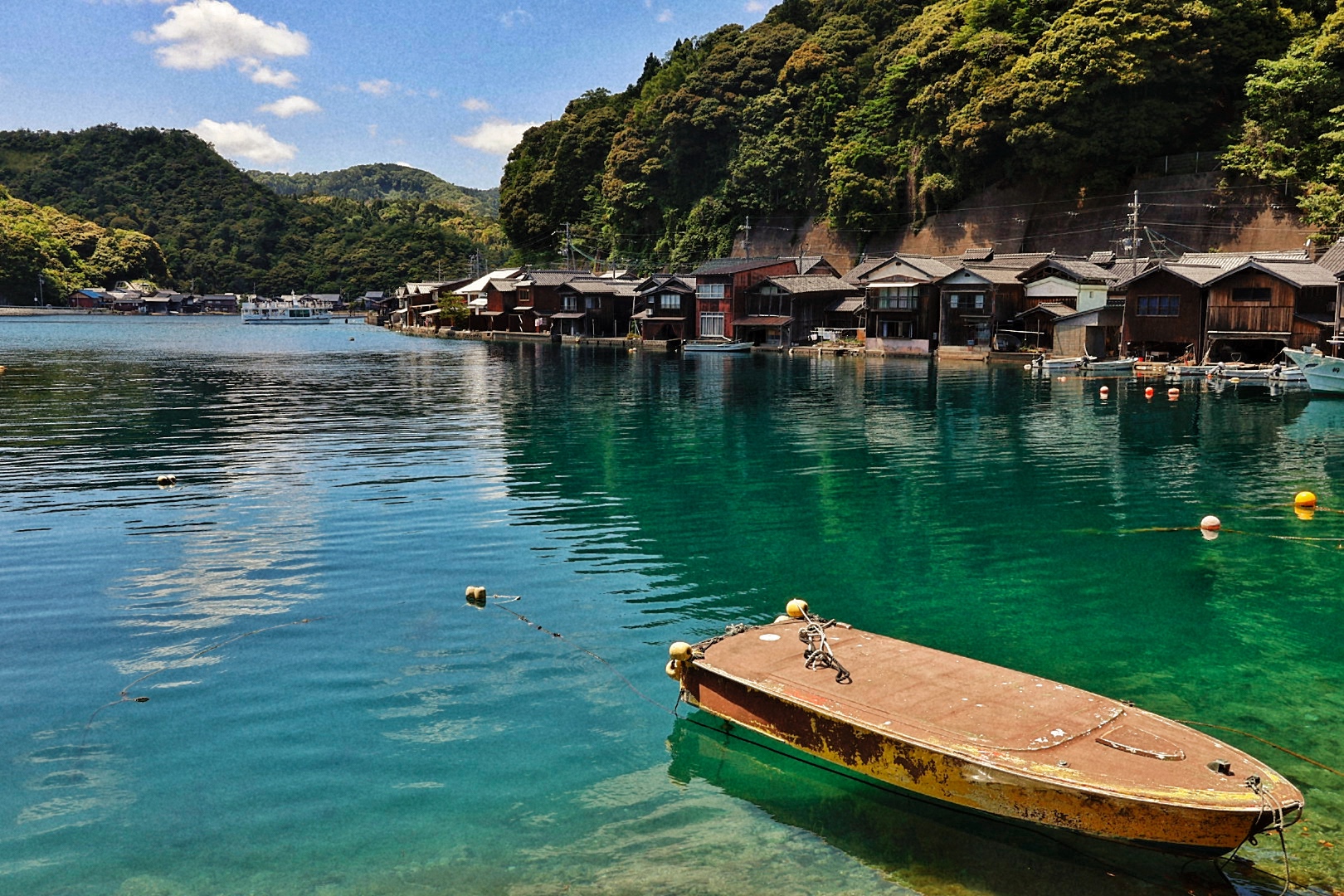 Traditional funaya boat houses lining turquoise water in the fishing village of Ine, Kyoto Prefecture