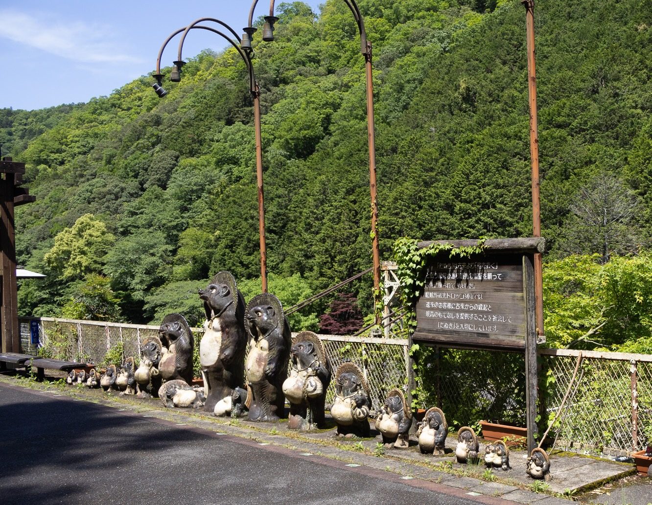 Row of tanuki statues at Hozukyo Station on the Sagano Scenic Railway